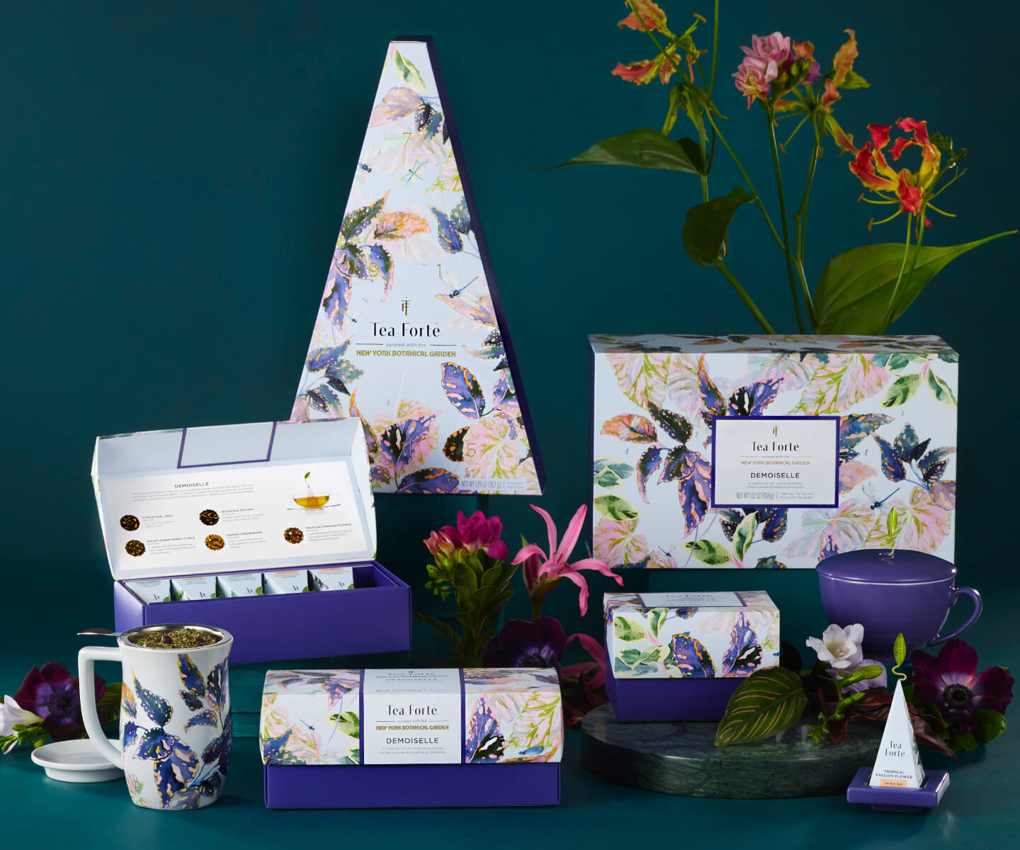 Demoiselle collection items displayed on a table with a glass cup of tea.