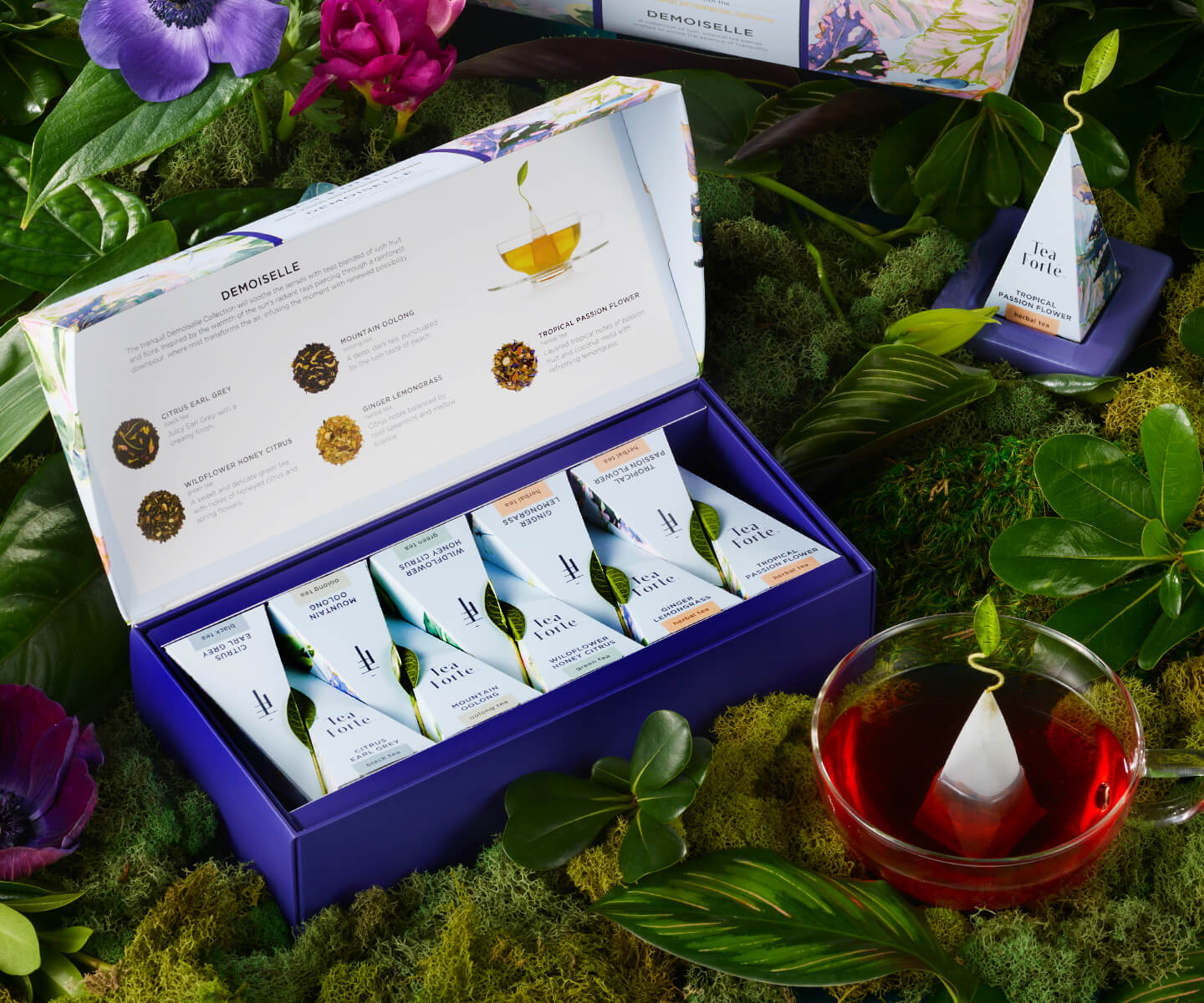 Tropical Passion Flower in a glass cup with a Petite Presentation Box on a bed of moss.